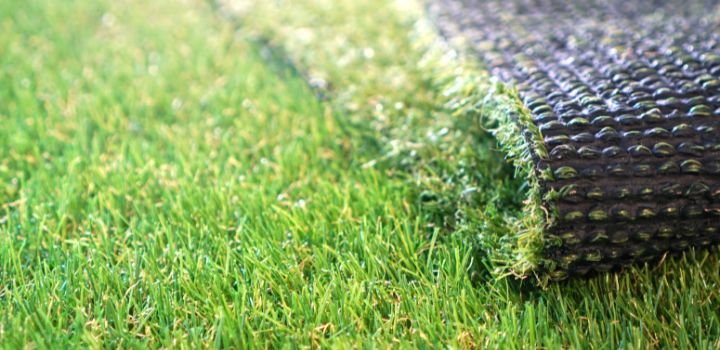 Greenering with an artificial grass. Artificial turf background.