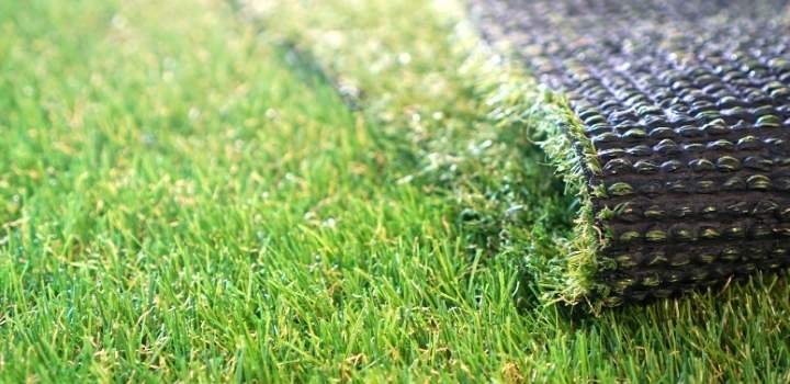 Greenering with an artificial grass. Artificial turf background.