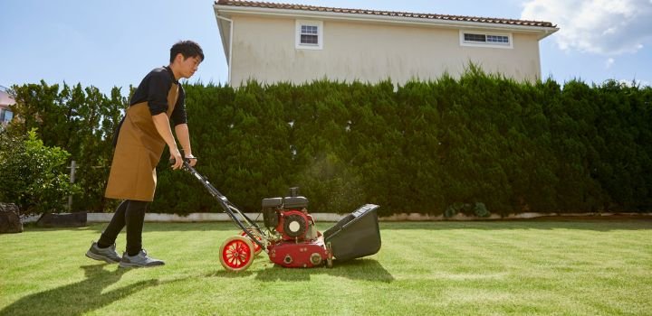 Man Mowing Lawn with a Gas Lawn Mower