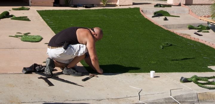 Man Installing Artificial Grass - Water Conservation