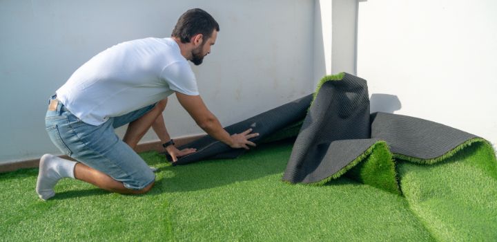 man installing artificial grass